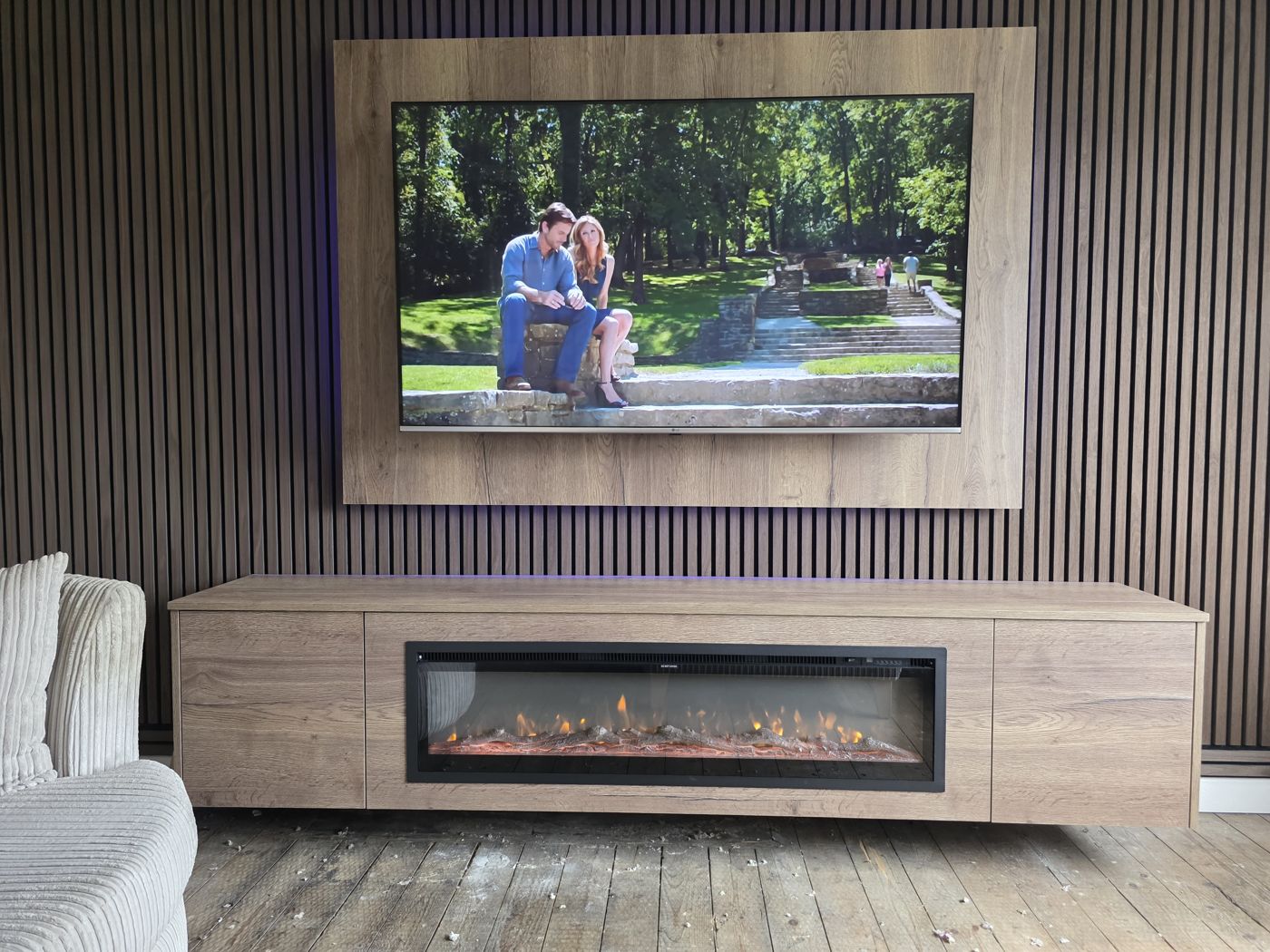 Light oak TV panel and charcoal slatted wall with purple LED, matching oak cabinet and long electric fire, Stirling.
