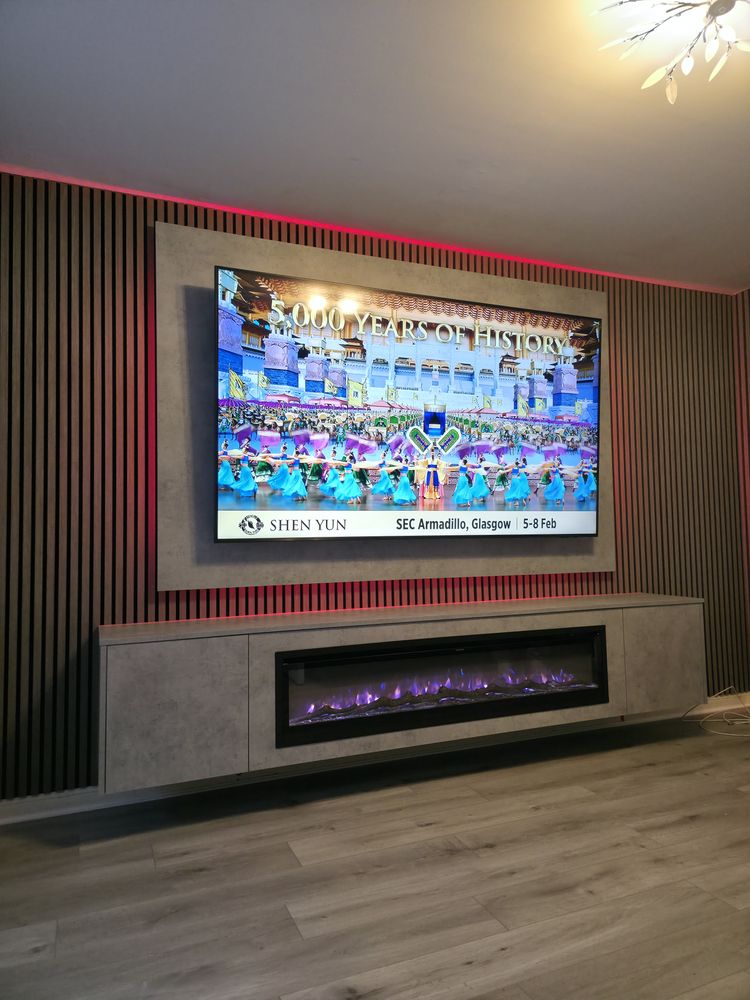 Front view of the light grey Chicago concrete media wall in Greenock, walnut slats, red LED backlighting and electric fire, by MPS Media Walls.