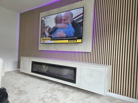 Oak slat feature wall with electric fire and LED glow