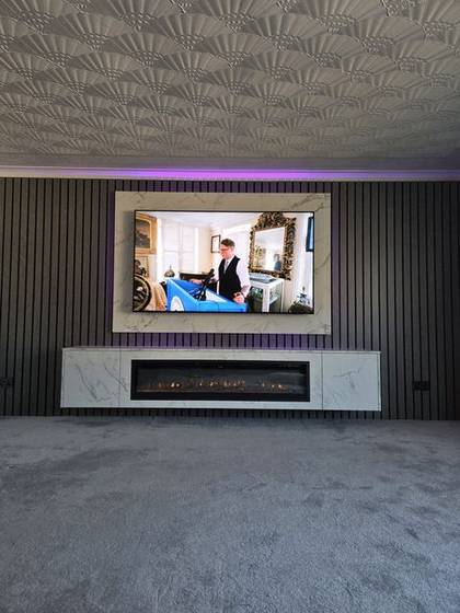 Grey slat media wall with marble TV panel and vertical marble fire column