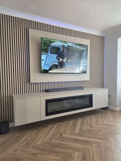 Cream slat media wall with linen-effect panel, soundbar and inset fire