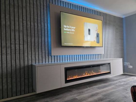 Concrete-effect slat wall with blue LED backlight and floating fireplace cabinet