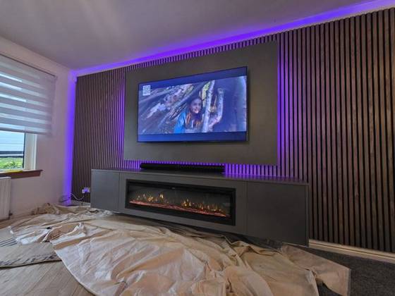 Walnut slat media wall with purple LEDs, soundbar and amber linear fire
