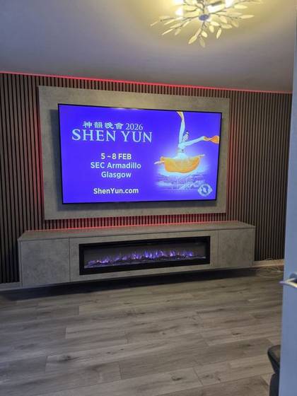 Walnut slat media wall with red LED glow and stone-effect fire column