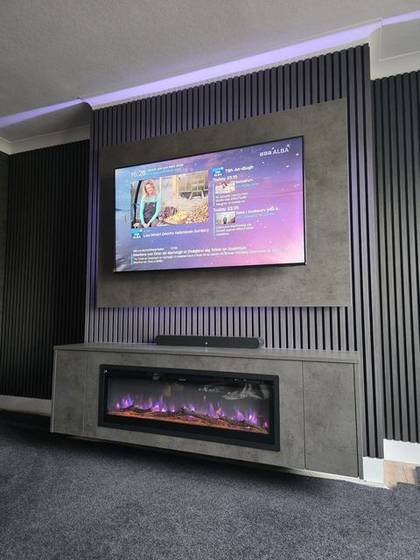 Grey slat media wall close-up with wall-mounted TV and log-effect electric fire