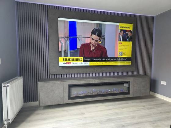 Grey slatted media wall with purple LED backlight and floating fireplace cabinet