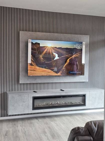 Slatted media wall with wall-mounted TV and tall inset electric fire