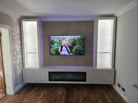 Cream media wall with lit display columns, oak slats and crystal-effect fire